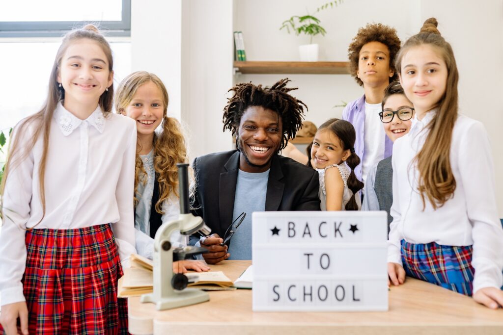 Smiling students and teacher ready for a healthy back-to-school year.